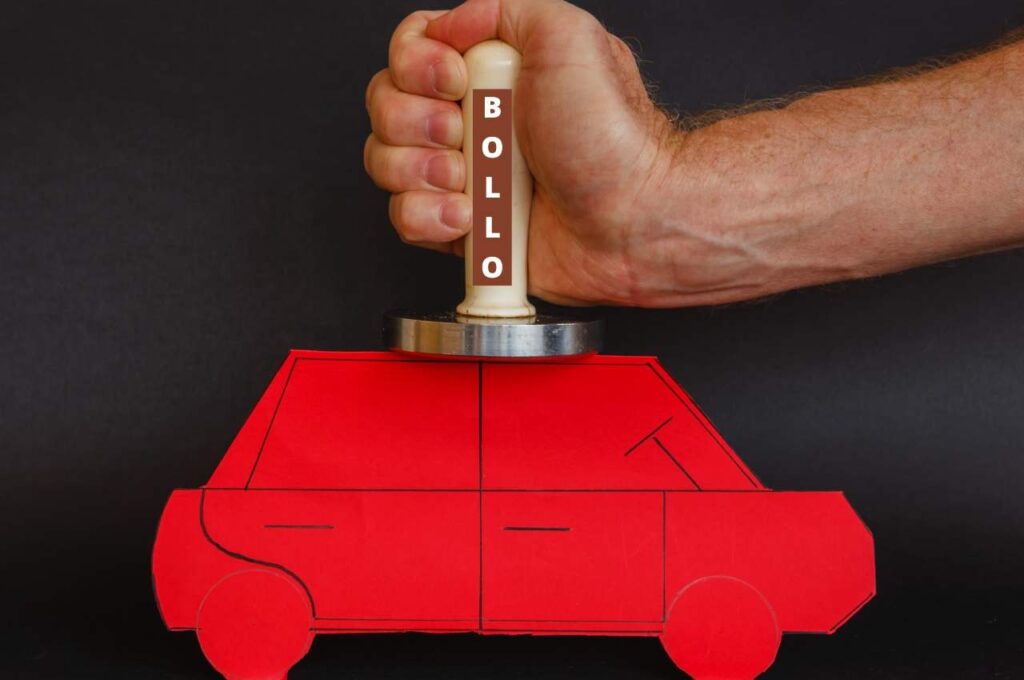 Illustrazione di un batti carne con scritto "bollo" che schiaccia un'auto di carta