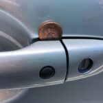 moneta sulla maniglia dell'auto