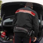 Carabiniere che controlla un bagagliaio