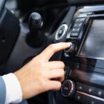 Donna che accende la radio in auto