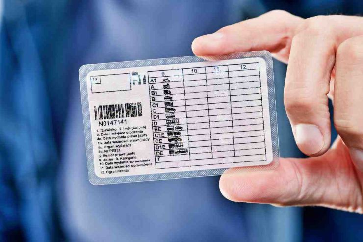 Uomo con una patente in mano