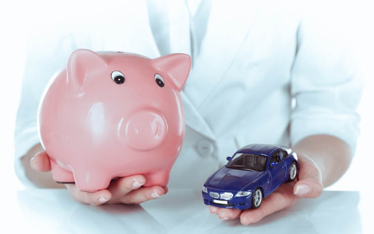 Uomo che tiene in mano un salvadanaio e un'auto giocattolo: risparmio