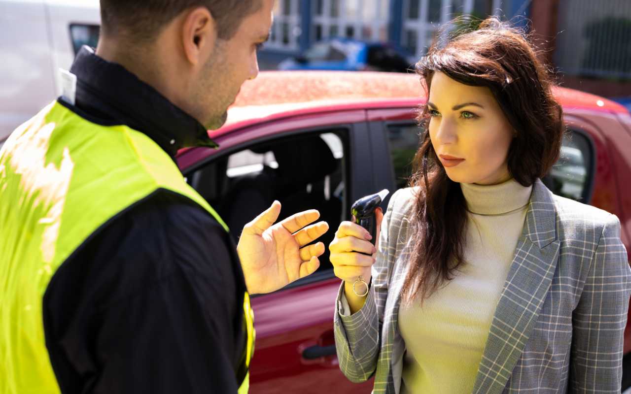 Donna che guarda il vigile che vuole sottoporla ad alcol test